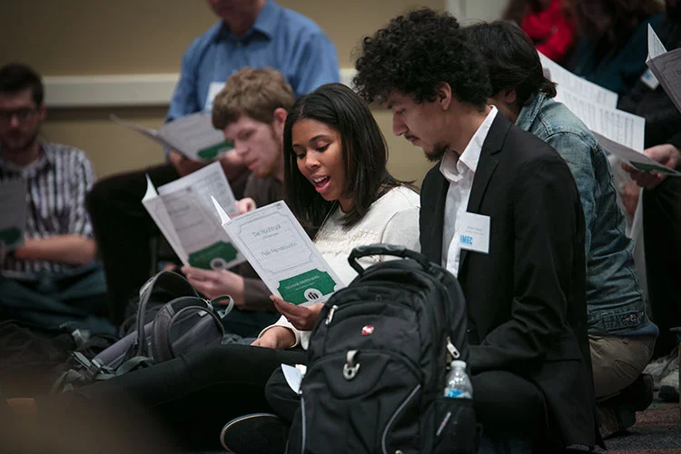 Two educators singing during a music reading session at the illinois music education conference. Click for current draft of conference schedule.