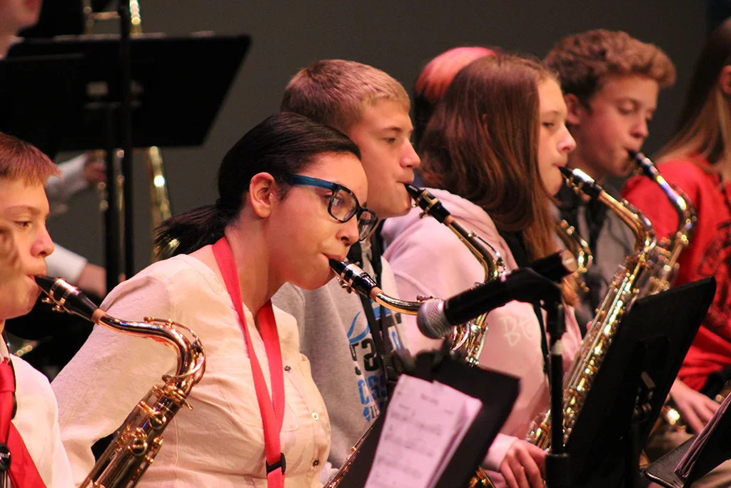 Junior high saxophone student in rehearsal at a jazz festival