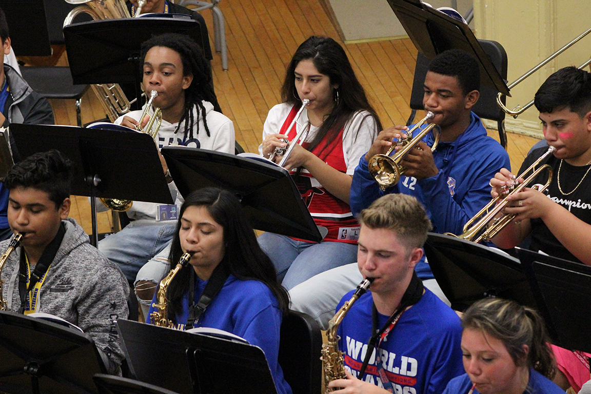 Students at Joliet Central High School rehearse on saxophones and trumpets.