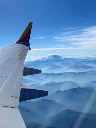 Stock Photo Silhouette Plane Wing Mountains.jpeg