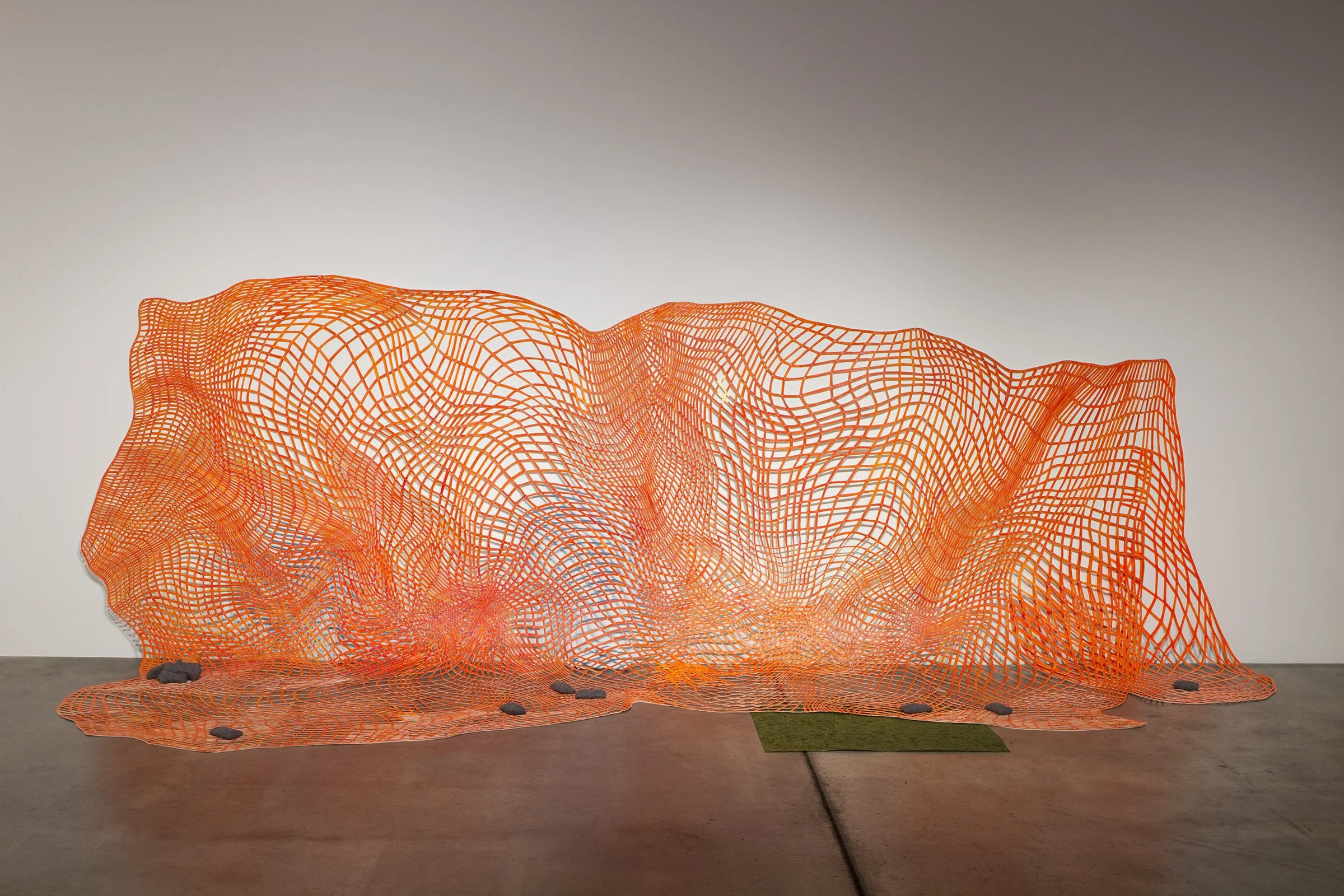 For Now: Safety Net , 2015 paper, acrylic paint, model turf, buckshot, upholstery vinyl and trunk liner 73” x 238” x 64”