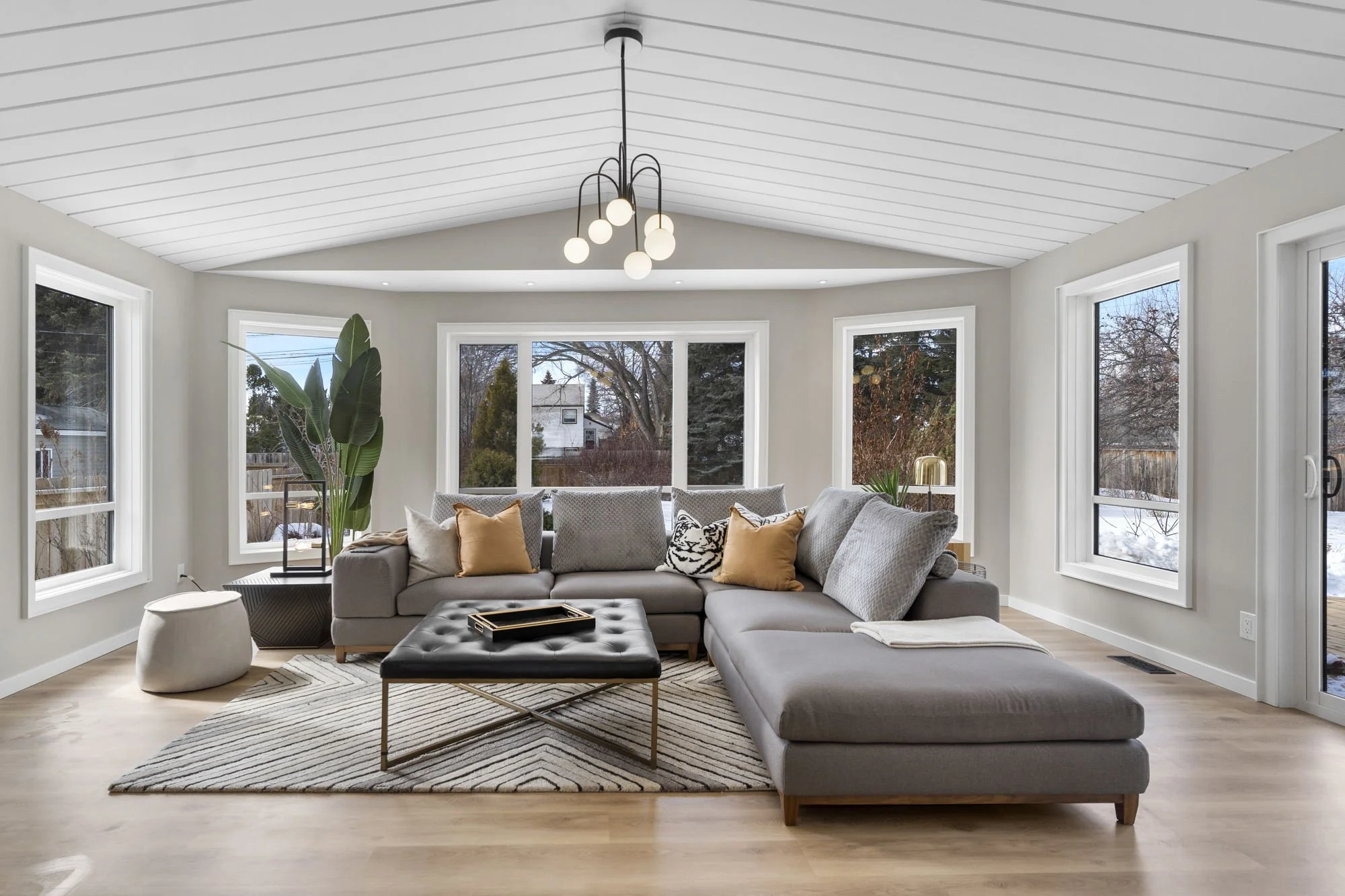 Iconic mid century house in Saskatoon is located in Grosvenor Park on Lake cres. Metric Design furnished beautifully with a gray oversized sectional and warm natural elements