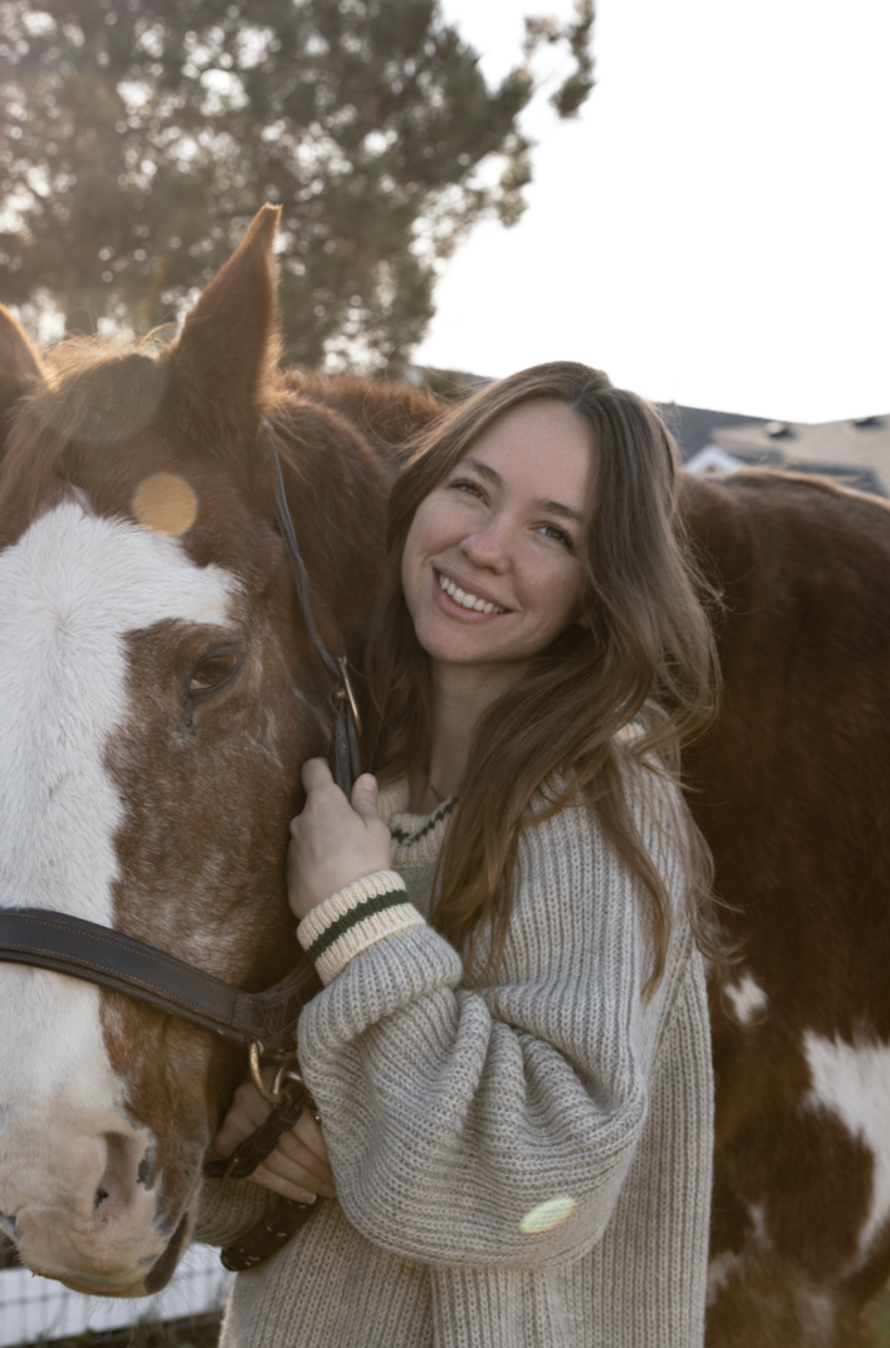 A woman with a chestnut paint horse