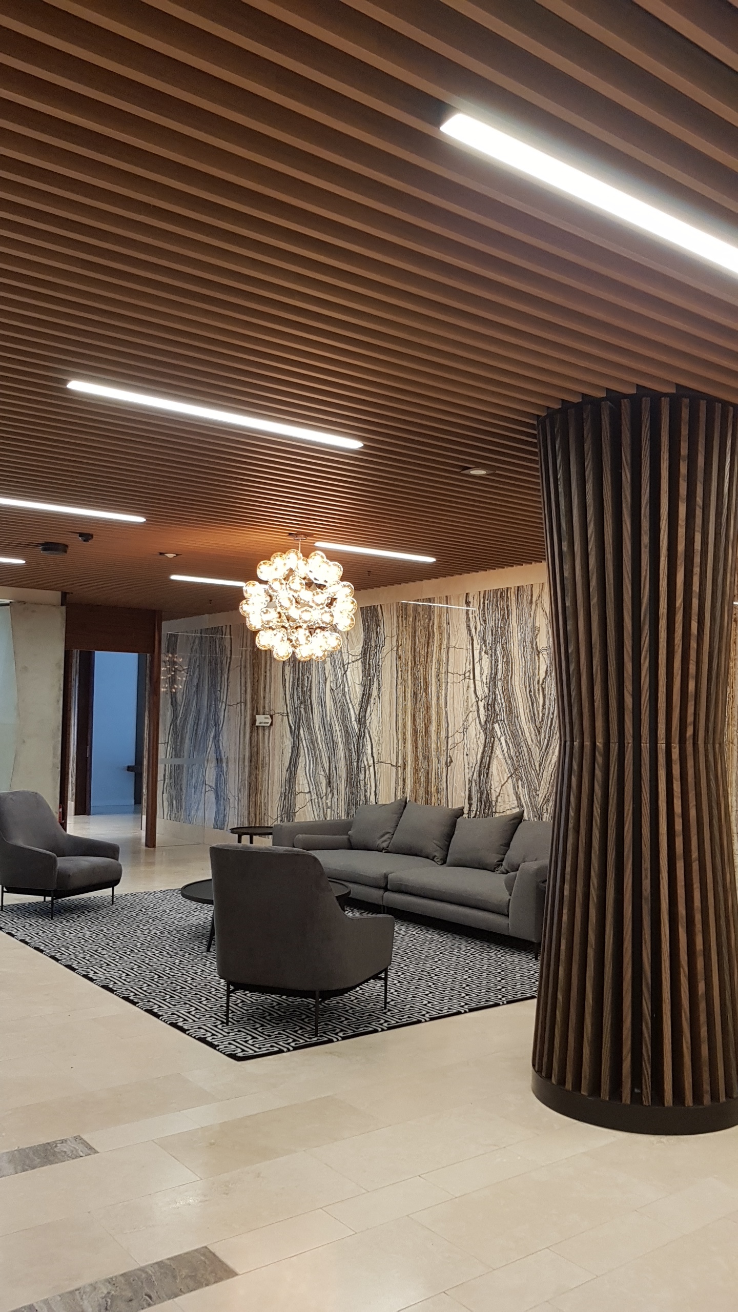 Lakeside Apartments Lobby - Melbourne VIC Ever Art Wood® Kabebari-T Suspended Ceiling System - Kabebari 30x85 battens in Kuri Masame; Custom powdercoated T section in Black 