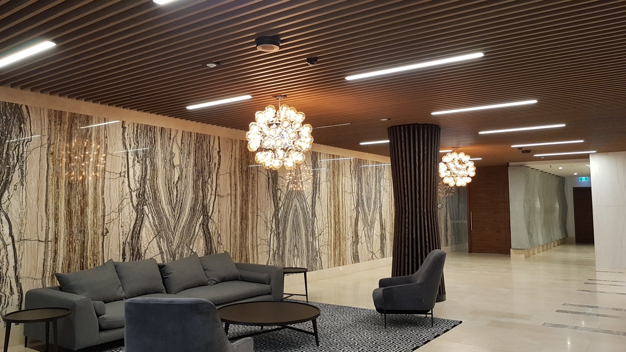  Lakeside Apartments Lobby - Melbourne VIC Ever Art Wood® Kabebari-T Suspended Ceiling System - Kabebari 30x85 battens in Kuri Masame; Custom powdercoated T section in Black 