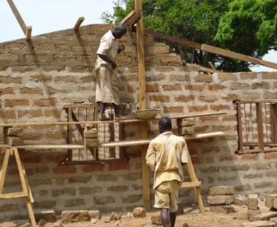 MenBuildingHouseWall.jpg