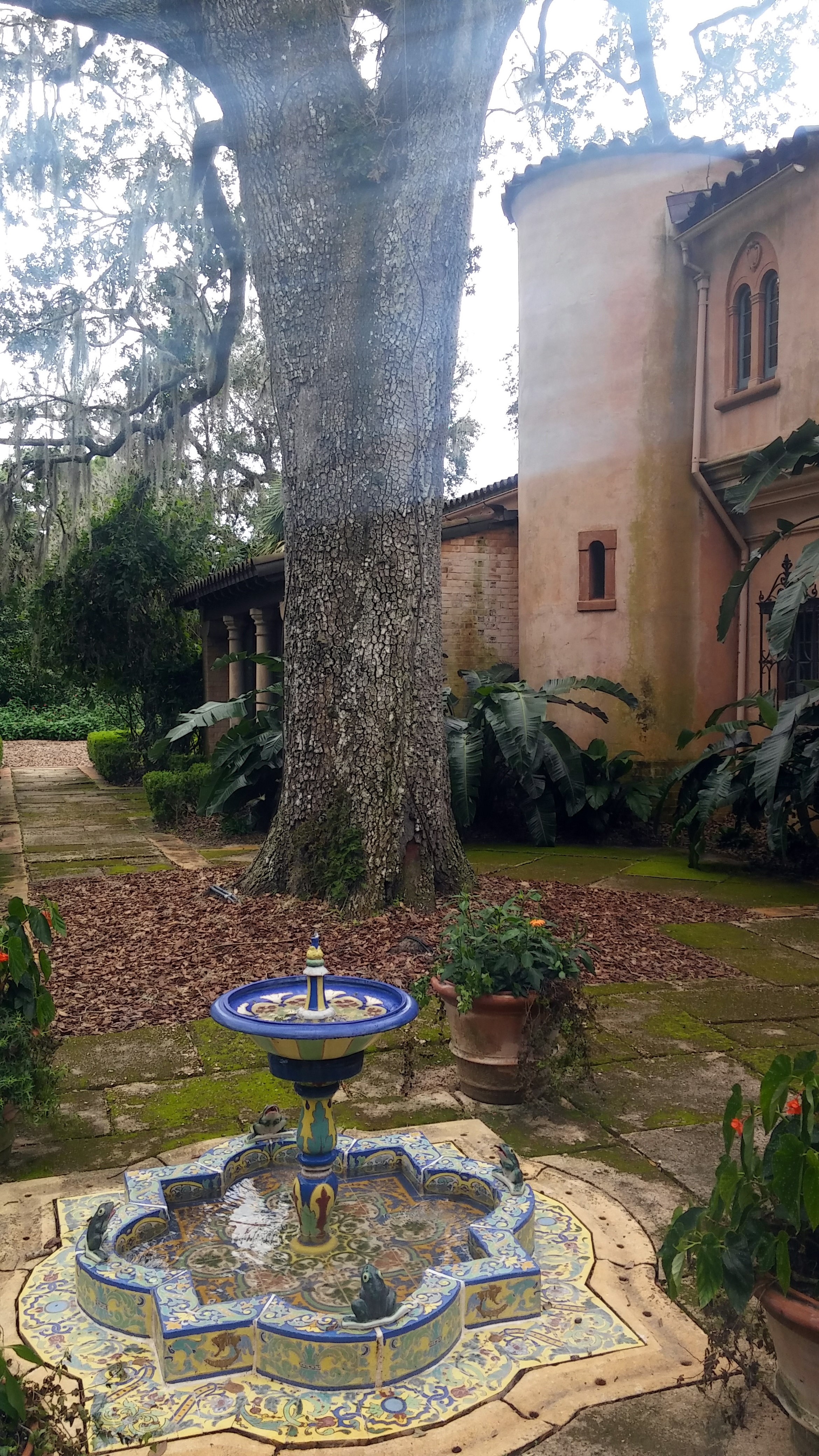 Almost a castle with a fancy little fountain.