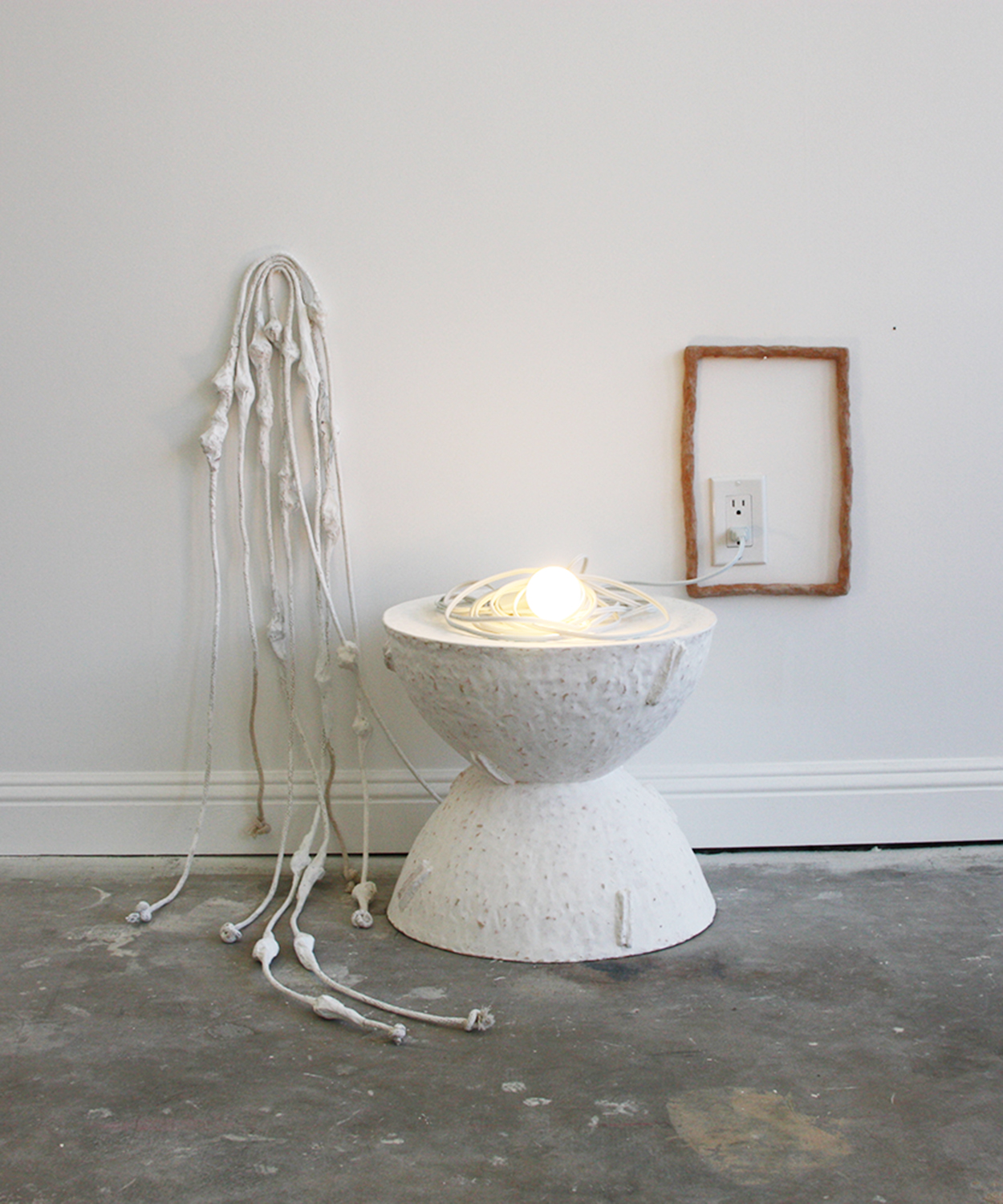   (Surface) Tension: A Release  Rope, ceramic, papier mâché, latex paint, light bulb Installation, dimensions vary 