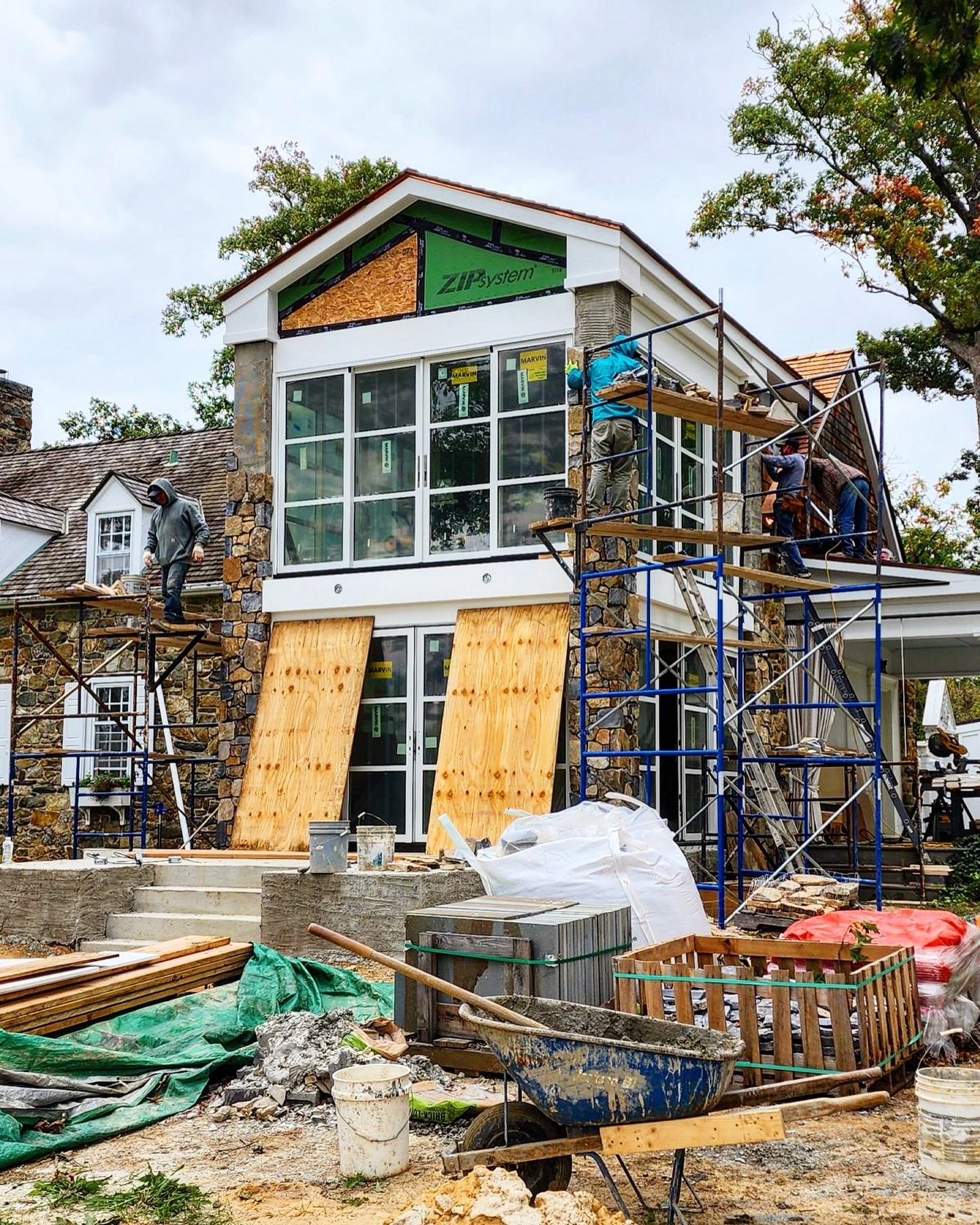 New stone and glass addition with a wood shingled roof, stone floors below with wide plank reclaimed pine floors above. Highly detailed, bespoke perfection, with a view of the Virginia Blue Ridge Mountains. #builder #design #custom #masonry #roomwith