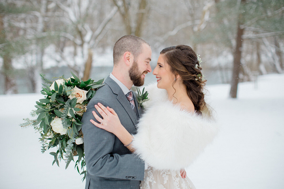 This romantic winter wedding in Lancaster, Pennsylvania features a neutral color palate, an apple cider bar, pie for dessert and a snowy backdrop. Photography by Brittany Frisch Photography.