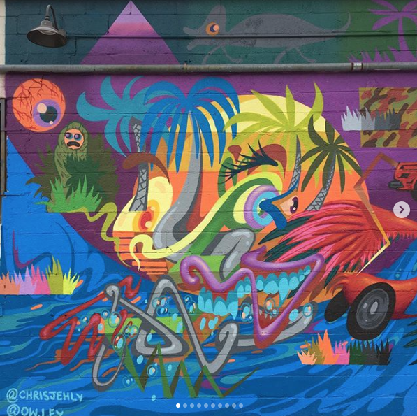 Chris Jehly. Brightly colored graffiti that combines palm trees and colorful monsters.