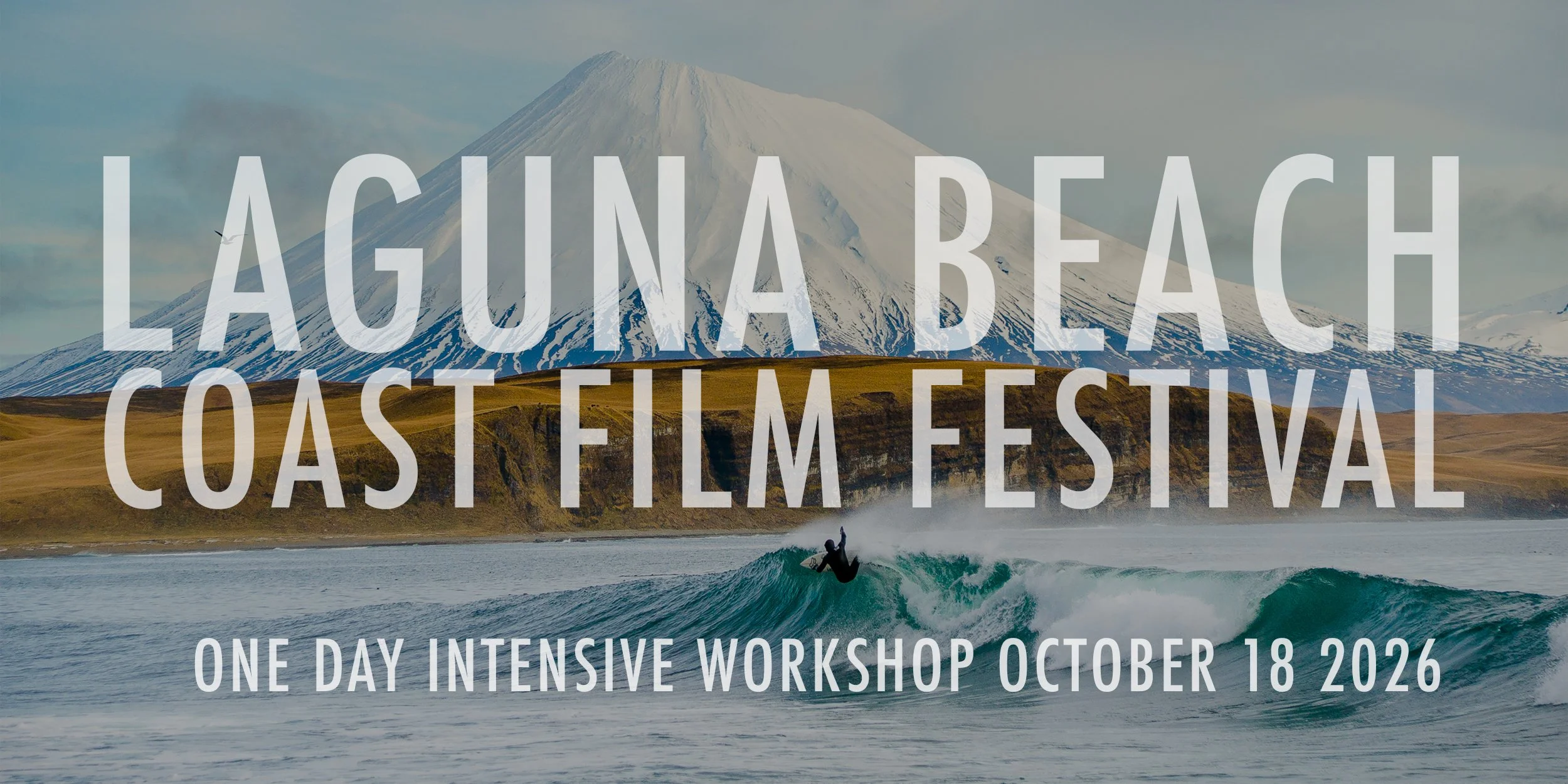 image of surfer cutting back in front of a snow covered volcano with the words 'LAGUNA BEACH' 'COAST FILM FESTIVAL' and 'ONE DAY INTENSIVE WORKSHOP OCTOBER 18 2026' overlaid in white modern font