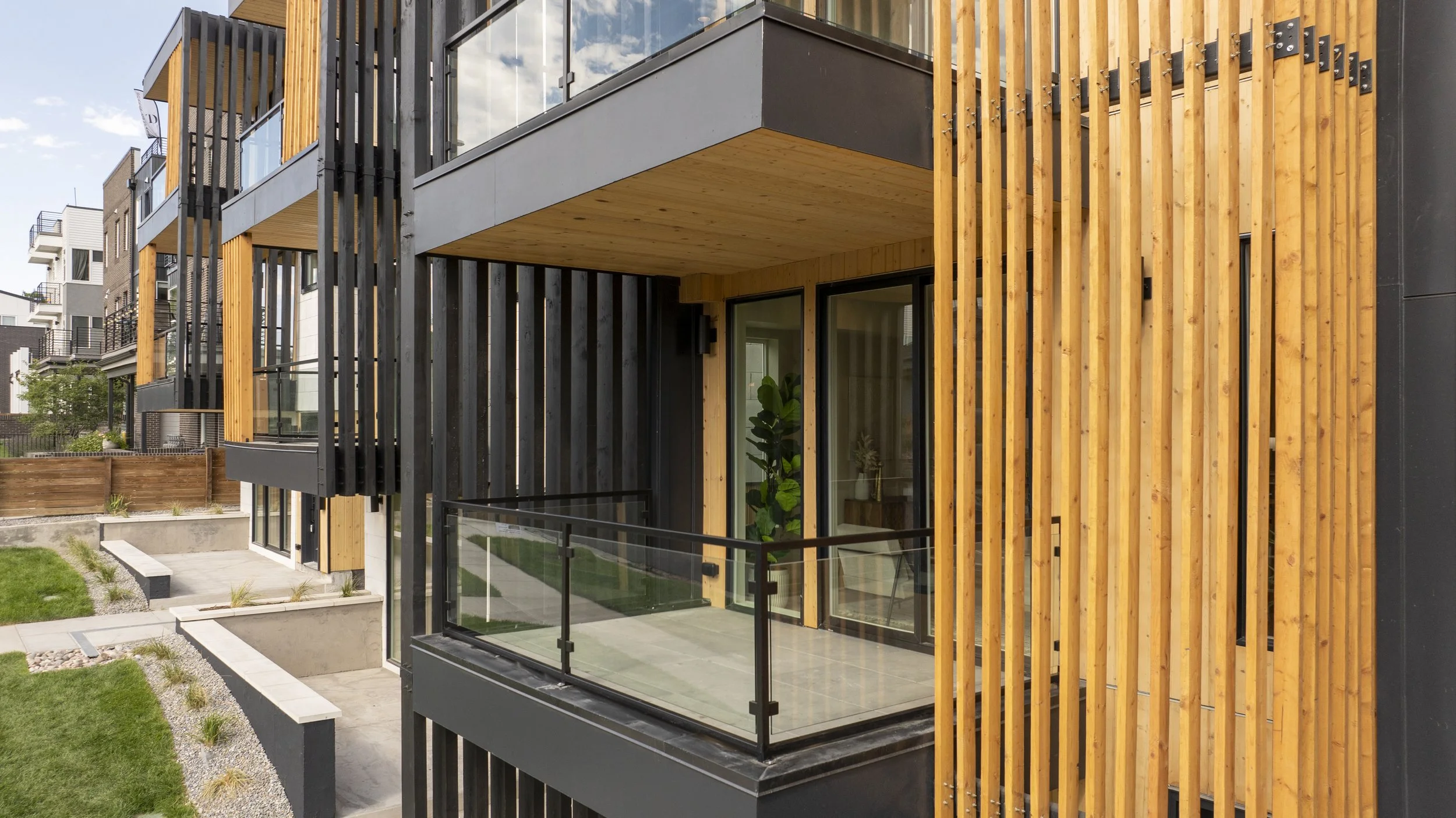 Stuart Residences balcony with wood slat screen and black metal cladding