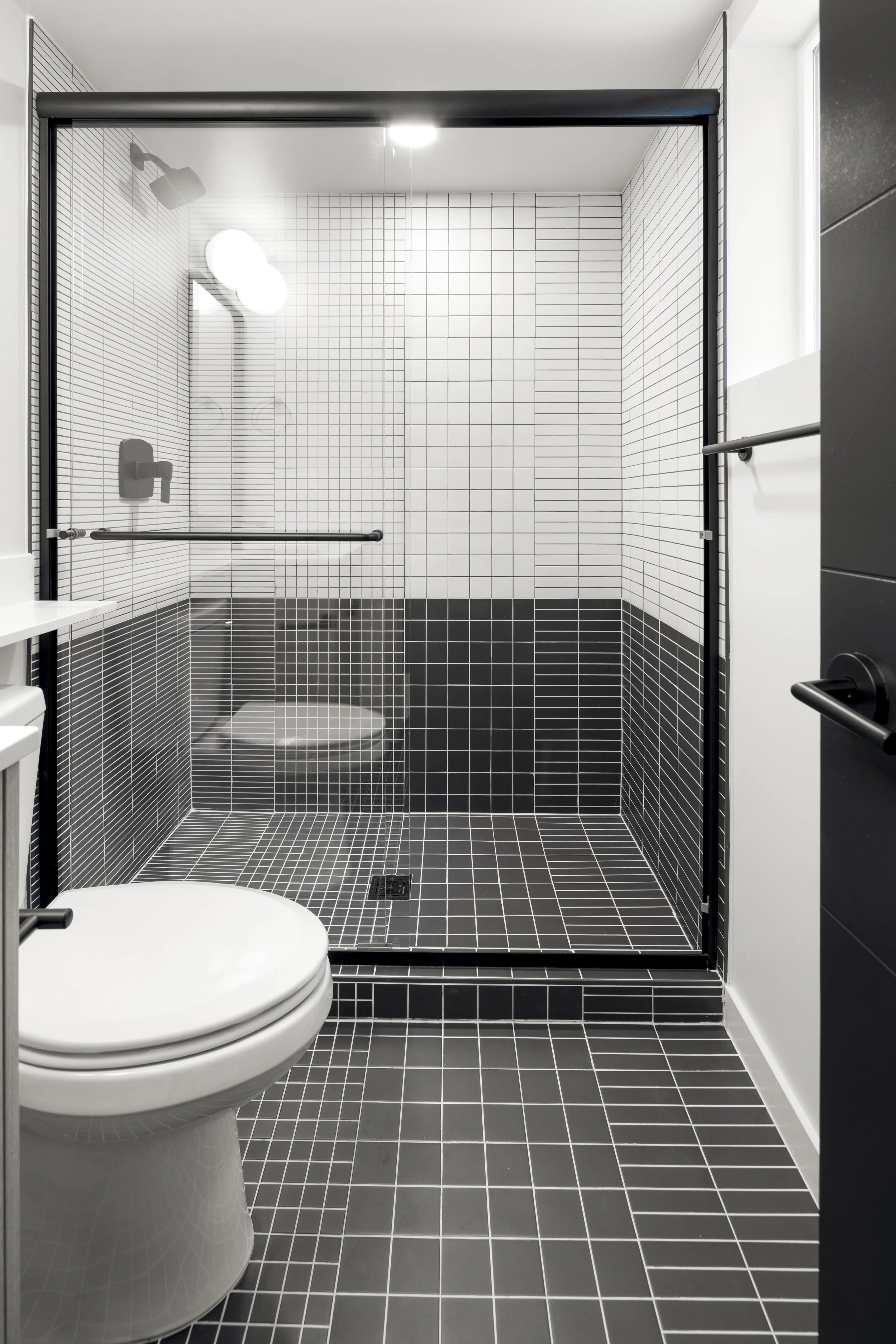 Stuart Residences bathroom with black grid tile shower