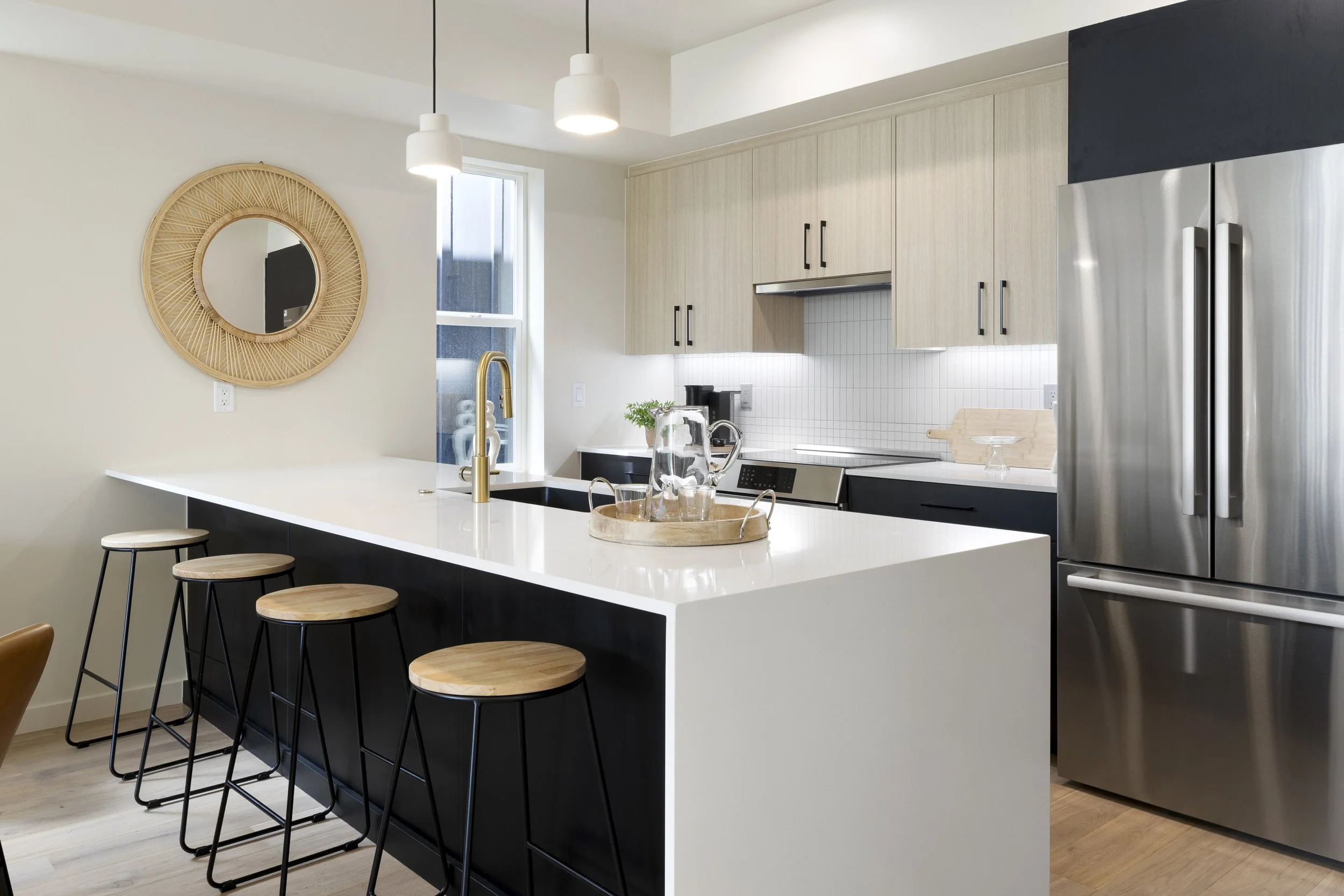 Stuart Residences kitchen with black island and white cabinetry