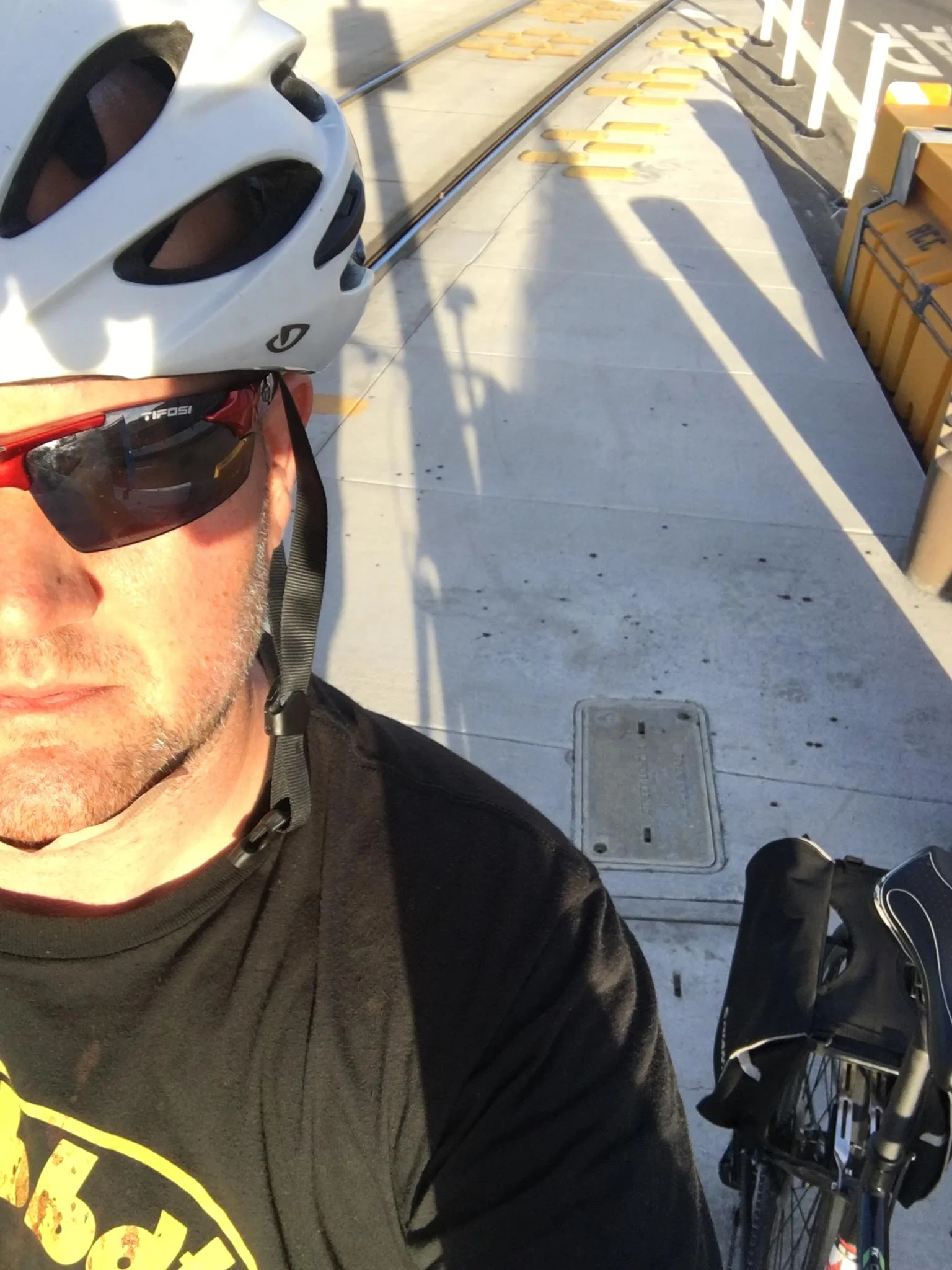 Returning to the accident scene a day later. Those large spots on the pavement over my shoulder was my blood.