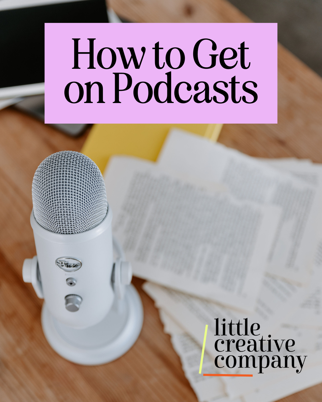 Little Creative Company desk with podcast mic and logo