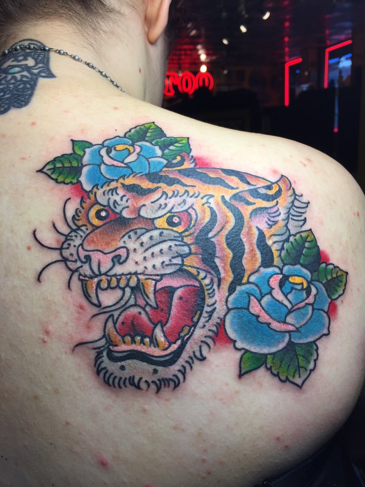 Tiger head tattoo with flowers on shoulder by Brian Gattis at Southern Star Tattoo in Atlanta, Georgia