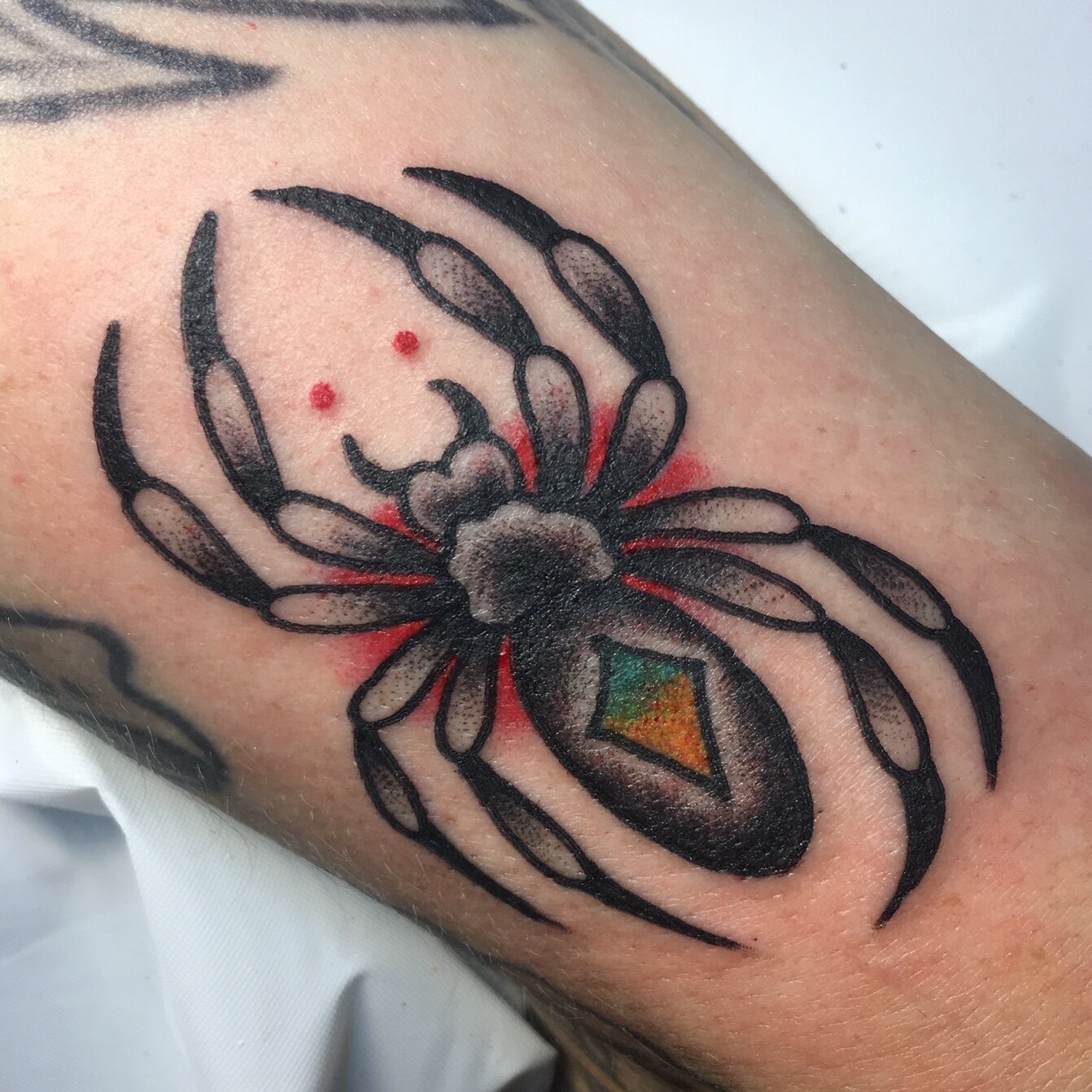 Traditional black widow spider tattoo by Brian Gattis at Southern Star Tattoo in Atlanta, Georgia