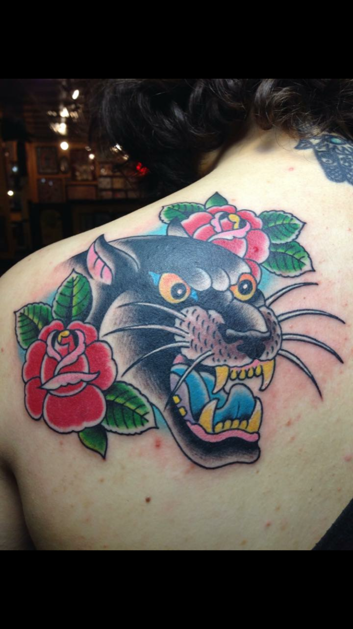 Large bold panther head tattoo with roses by Brian Gattis at Southern Star Tattoo in Atlanta, Georgia