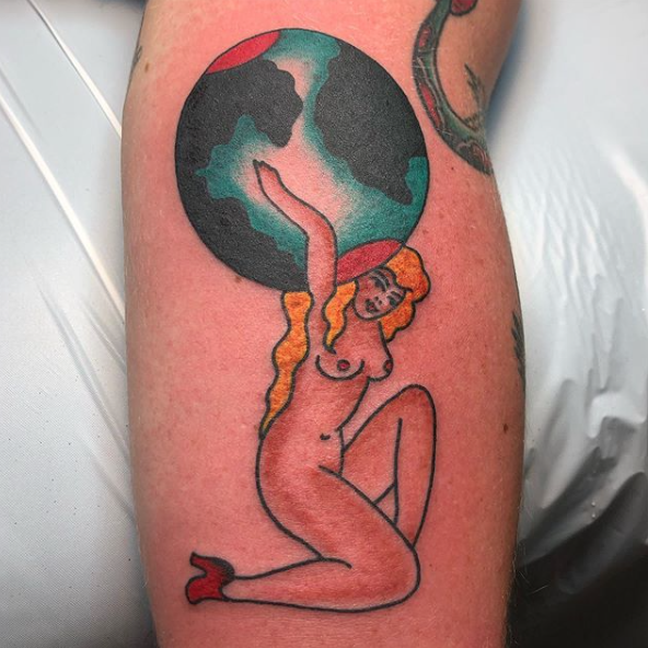 Traditional pin up tattoo of girl holding globe by Brian Gattis at Southern Star Tattoo in Atlanta, Georgia