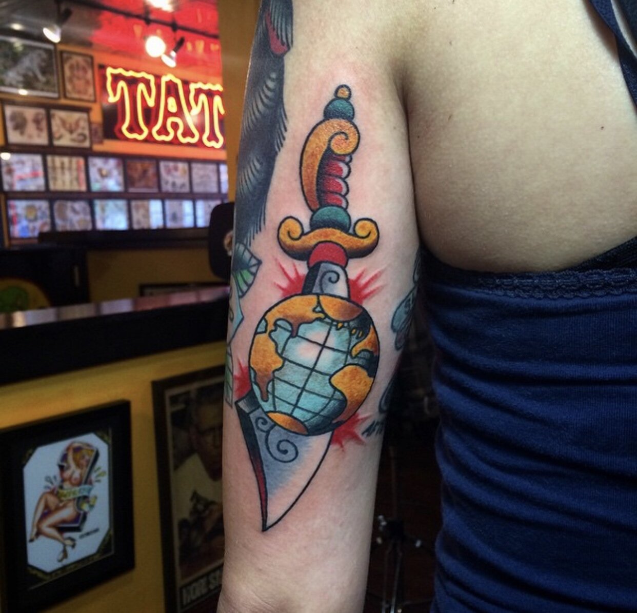 Sword and globe tattoo in bold color by Andrew Patch at Southern Star Tattoo in Atlanta, Georgia.