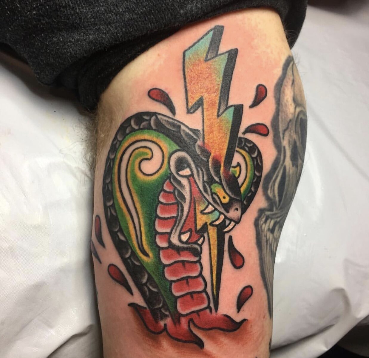 Corba snake tattoo with lighting bolt by Andrew Patch at Southern Star Tattoo in Atlanta, Georgia.