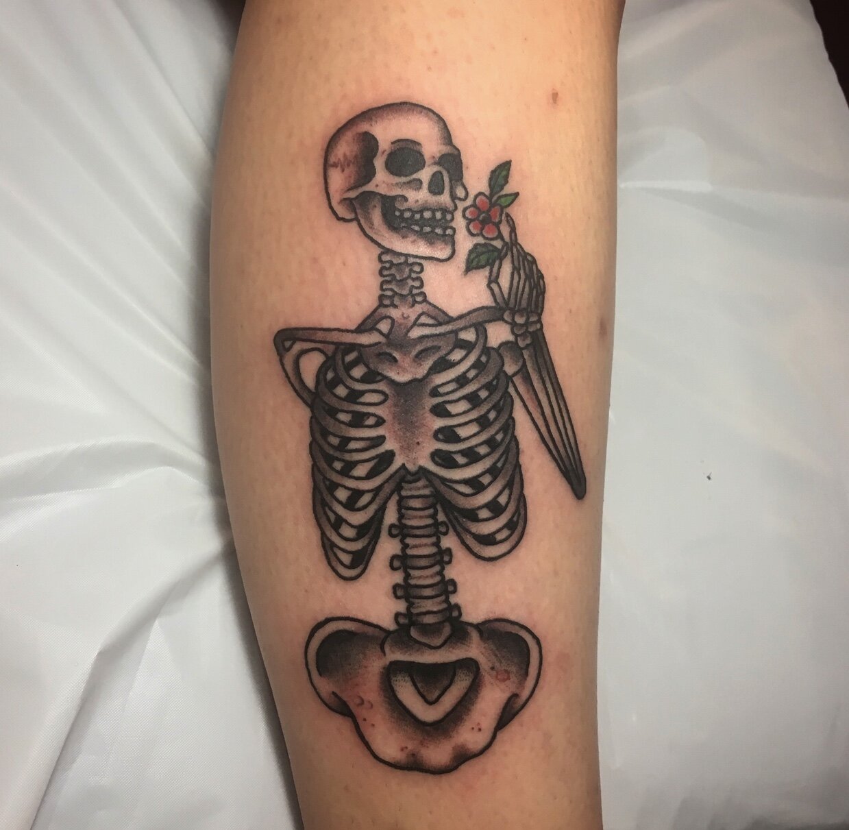 Skelton holding flower tattoo by Andrew Patch at Southern Star Tattoo in Atlanta, Georgia.