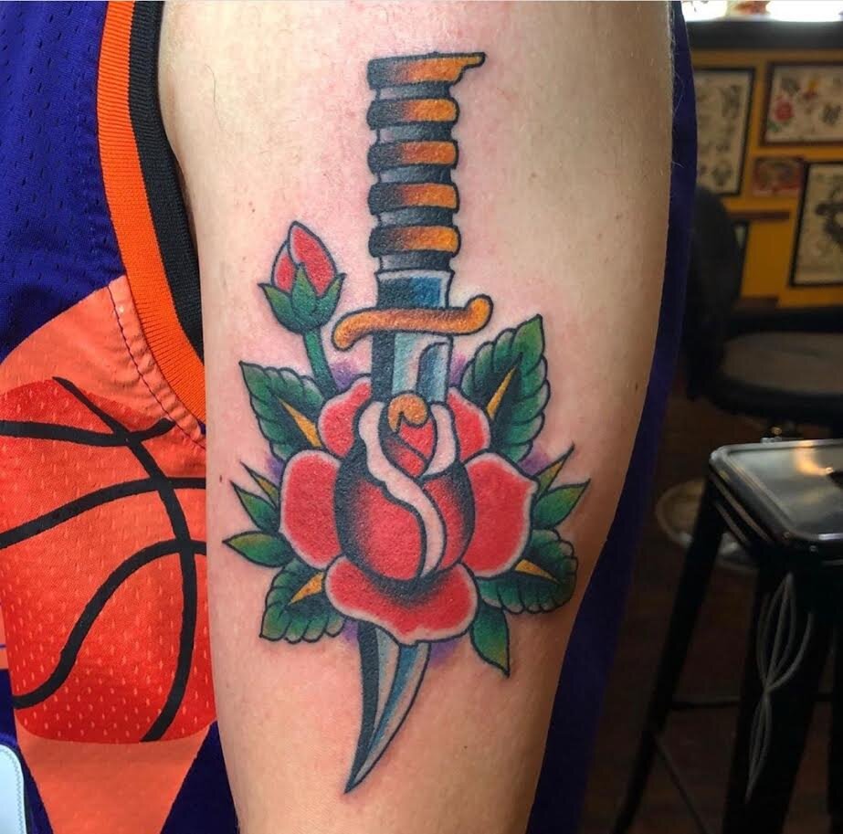 Traditional dagger with rose tattoo in bold color by Andrew Patch at Southern Star Tattoo in Atlanta, Georgia.