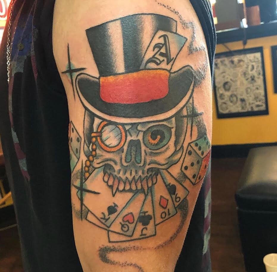 Top hat wearing skull tattoo by Andrew Patch at Southern Star Tattoo in Atlanta, Georgia.