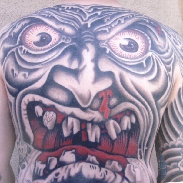 Large back tattoo of creepy face by Josh Hanes at Southern Star Tattoo in Atlanta, Georgia