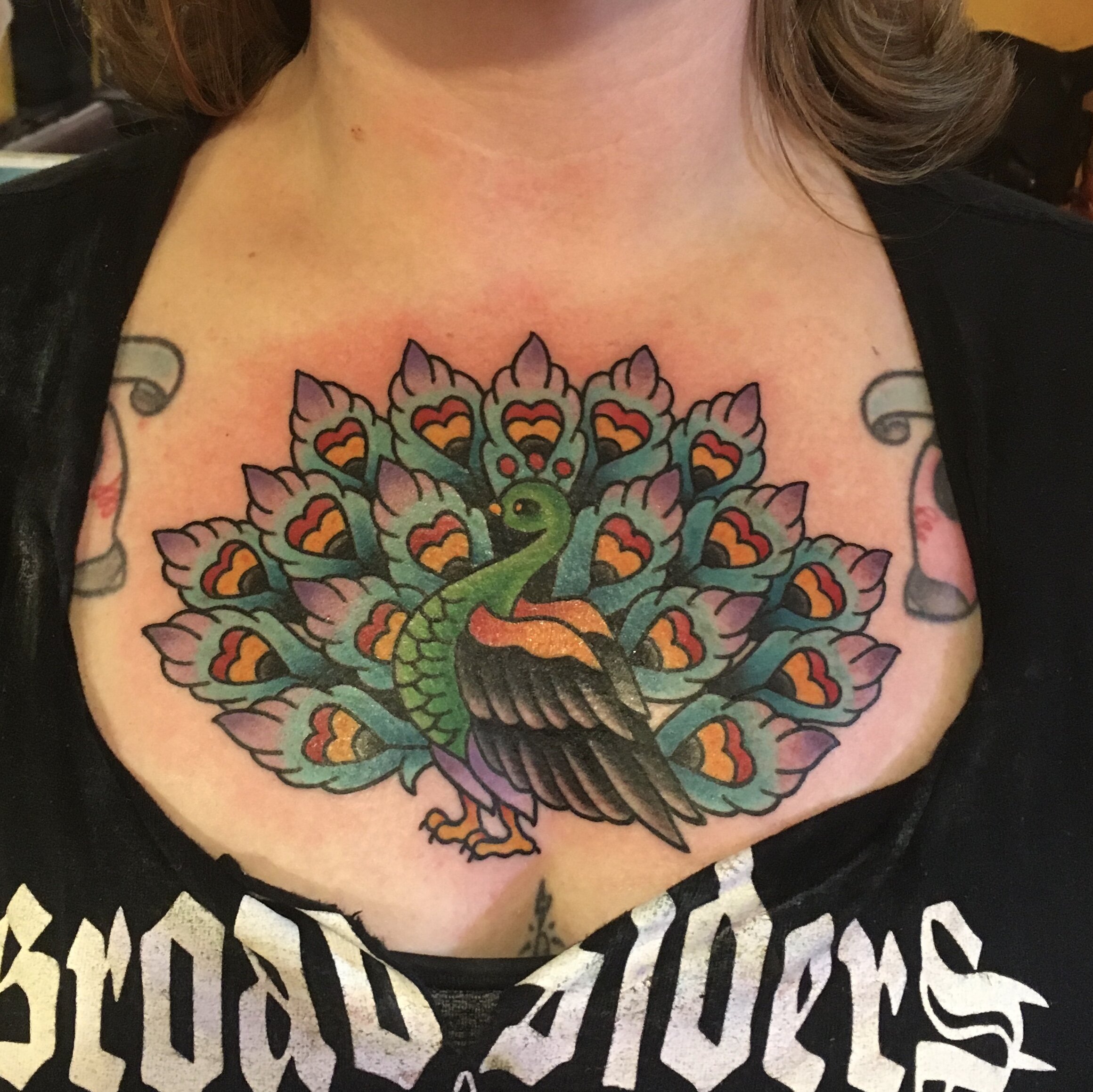 Bold color peacock tattoo on chest by Josh Hanes at Southern Star Tattoo in Atlanta, Georgia