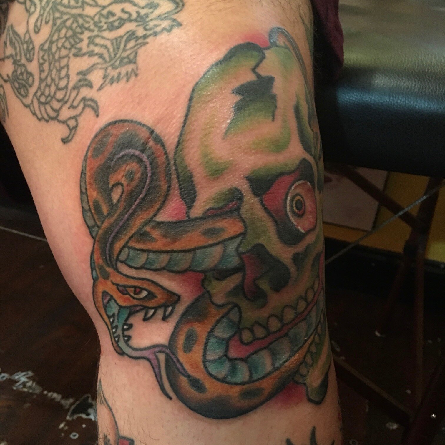 Skull and snake tattoo on knee by Josh Hanes at Southern Star Tattoo in Atlanta, Georgia