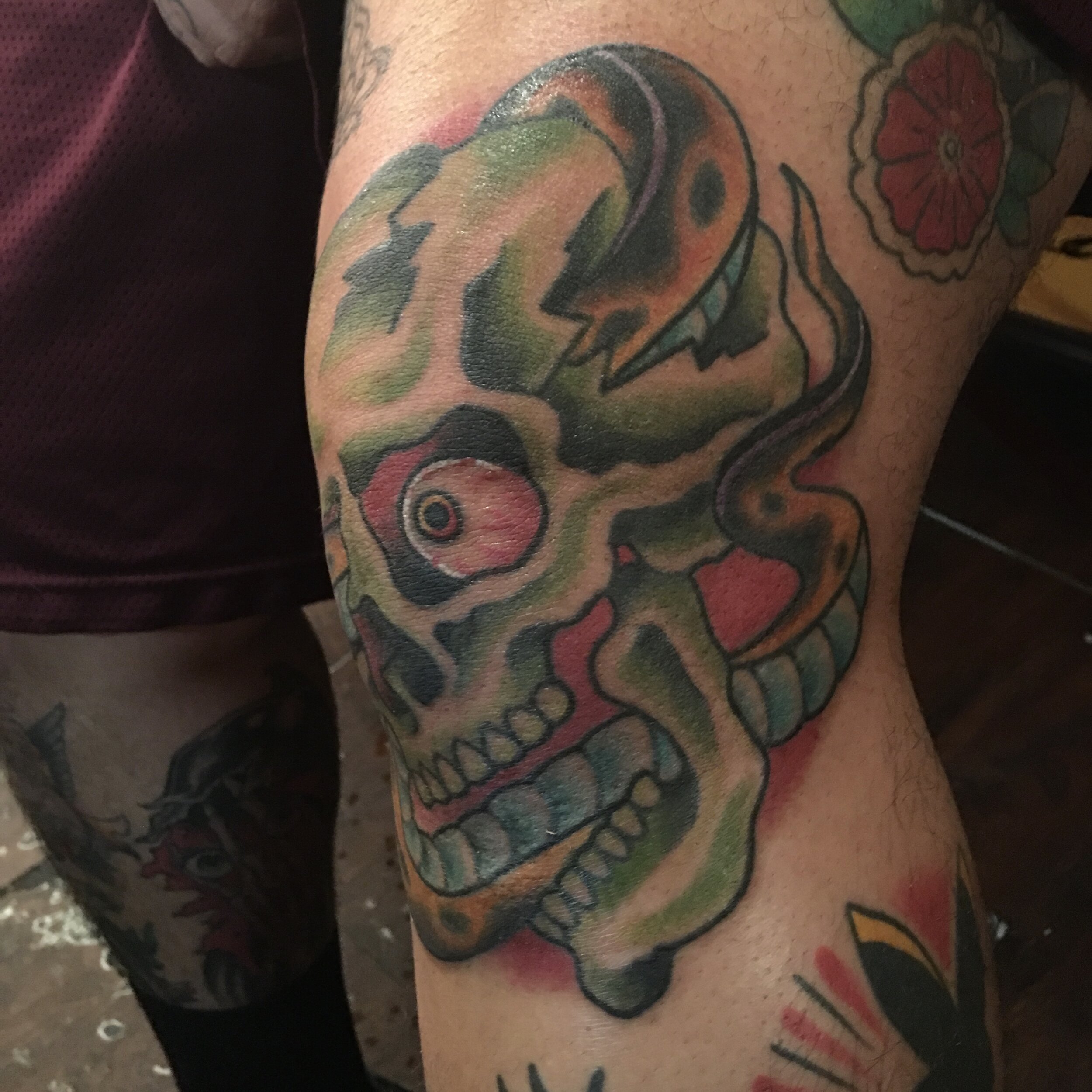 Skull and snake tattoo on knee by Josh Hanes at Southern Star Tattoo in Atlanta, Georgia