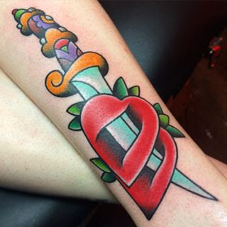 Traditional Americana bold color dagger through heart tattoo by Demian Bouchan at Southern Star Tattoo in Atlanta, Georgia