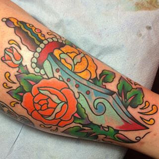 Traditional roses and dagger tattoo by Demian Bouchan at Southern Star Tattoo in Atlanta, Georgia