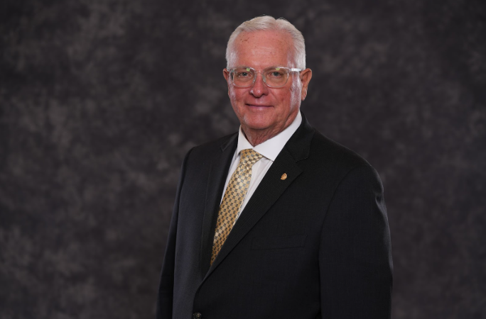 Headshot of Past Grand Master Greg Clark in business attire
