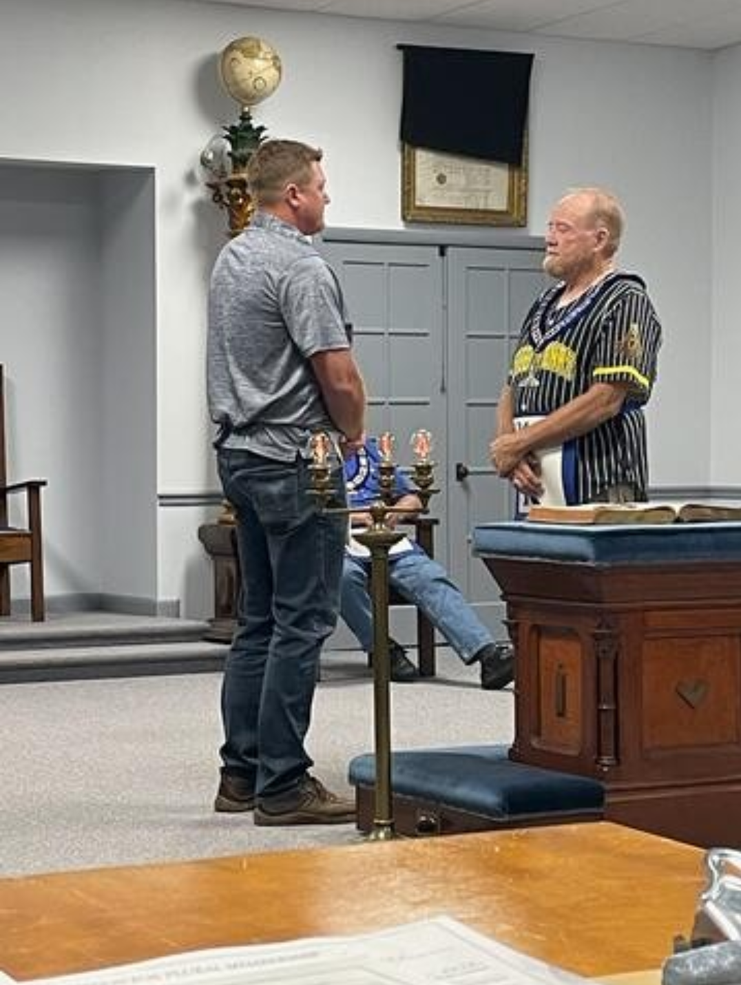 Mark Carlen and Marshall Carlen, Illinois Freemasons, standing across from each other during a Masonic raising