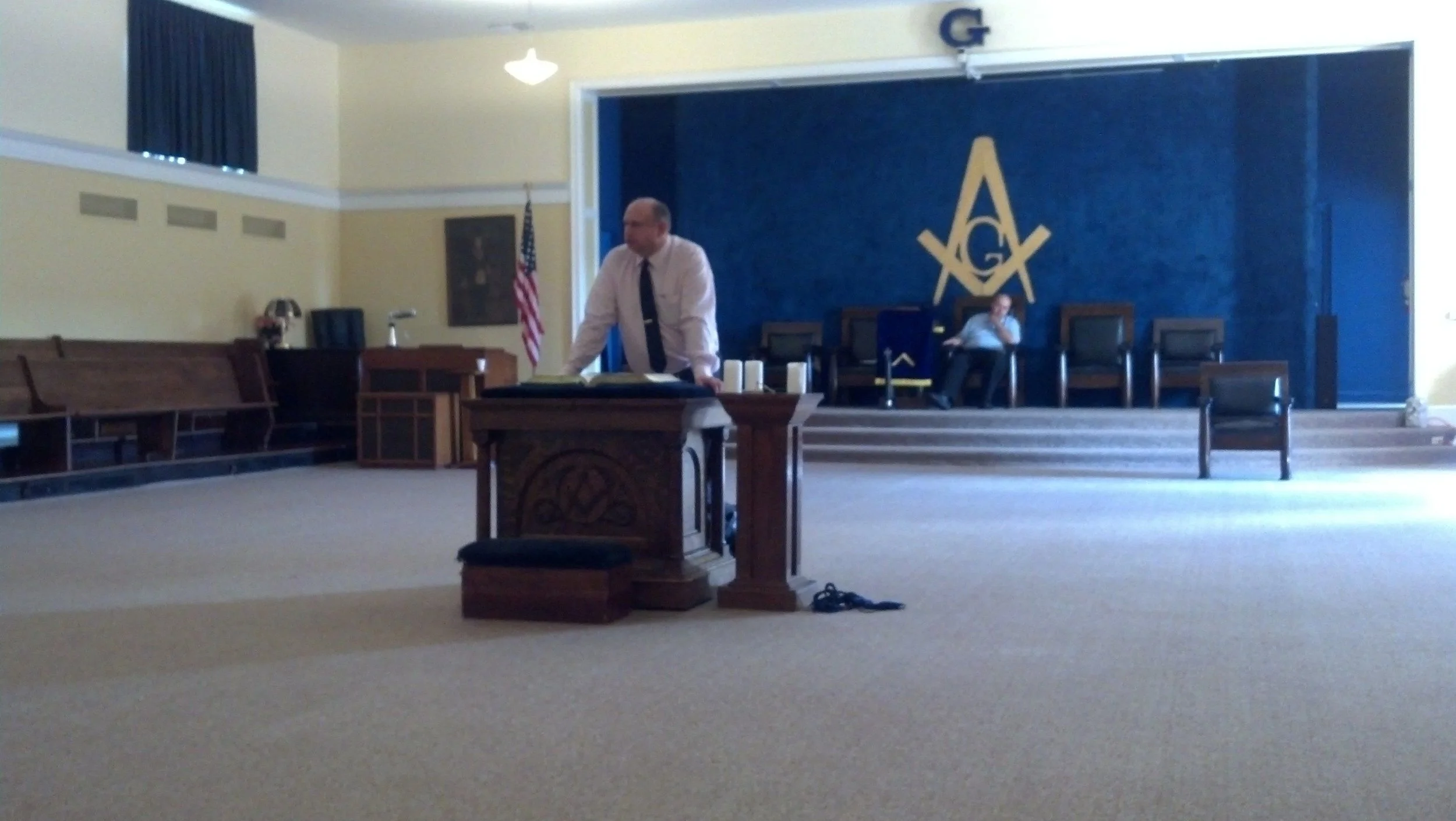 Freemason James “Jim” Brown standing at a podium at a Masonic School of Instruction in Downers Grove, Illinois