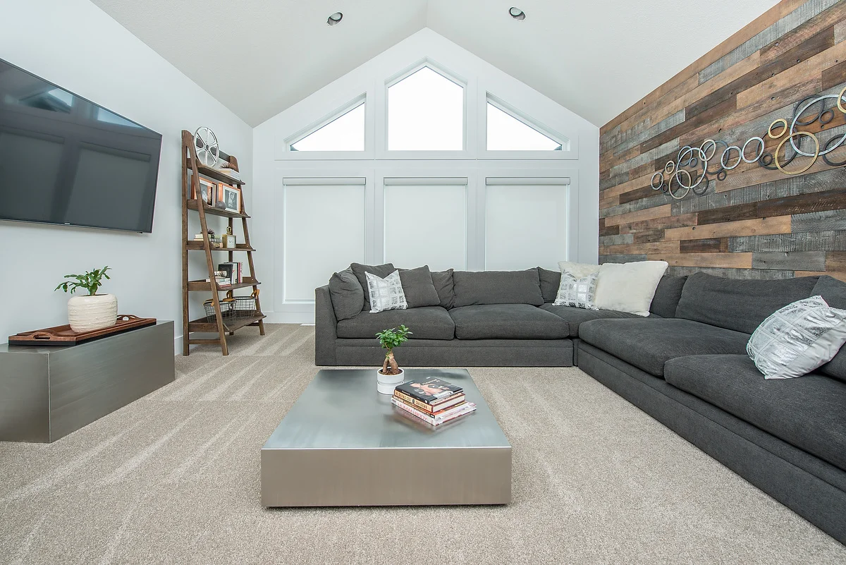 The hardness of the metallic tables is softened by the feature wall and textured sectional.