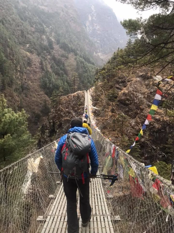 Trekking across rope bridge.jpg