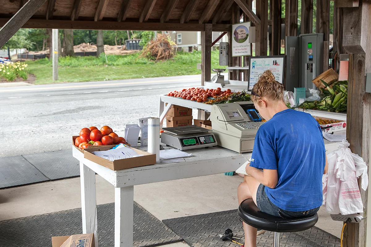 Nora waits for customers at the family farm stand