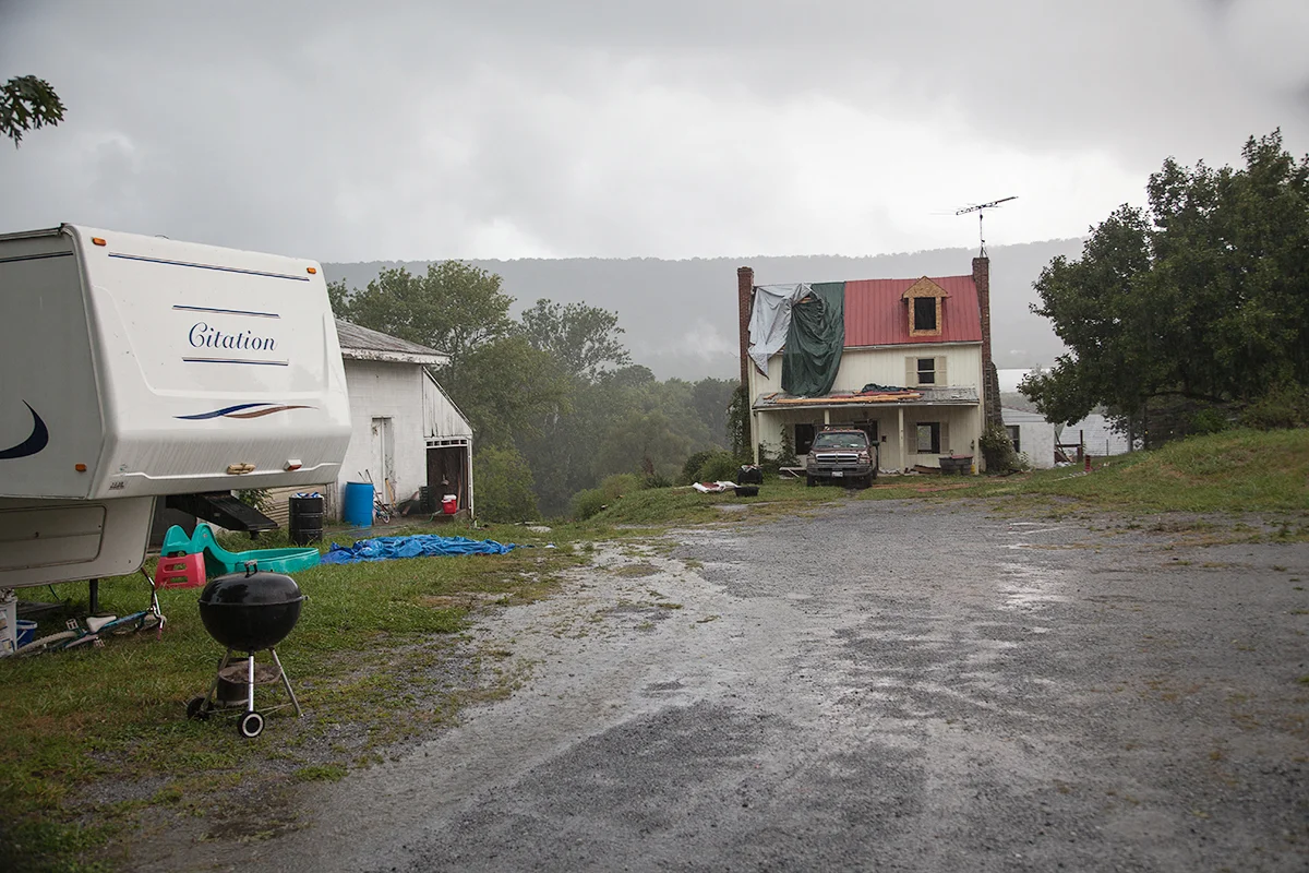 The house under renovation and a trailer to call home