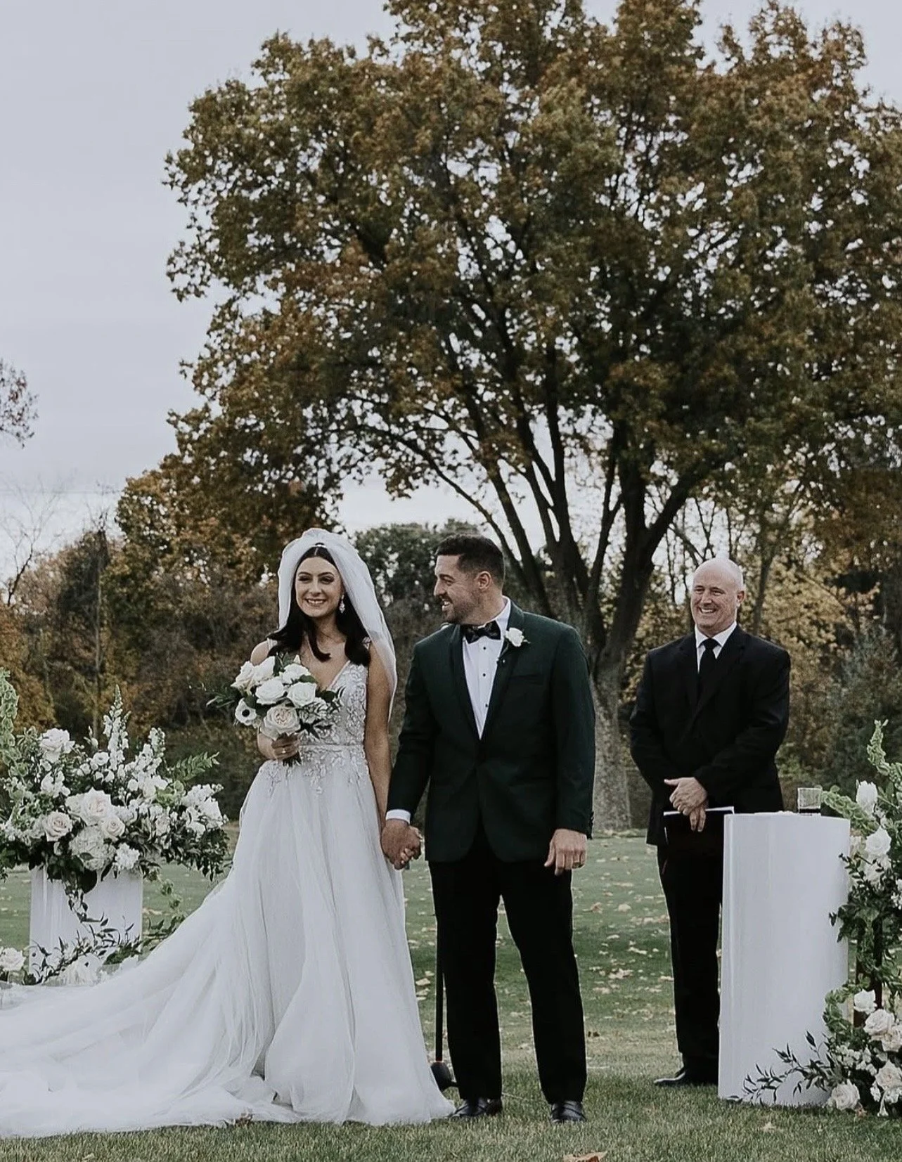 Bride and Groom at Oakmont Country Club with modern romantic ceremony florals and a bridal bouquet designed by a Pittsburgh wedding florist.
