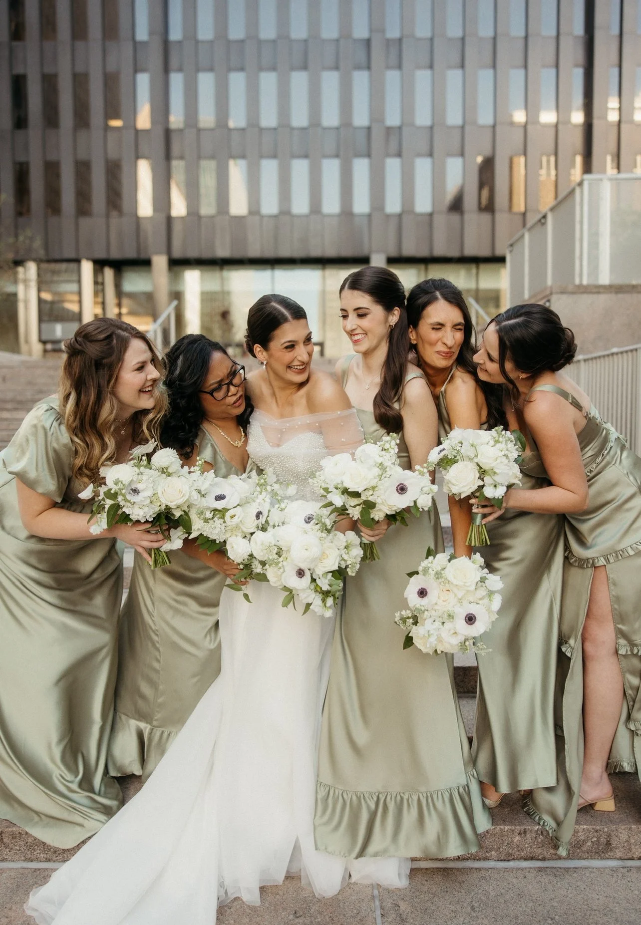 Bride and Bridesmaids holding  floral bouquets at the Wintergarden PPG designed by a Pittsburgh wedding and event florist