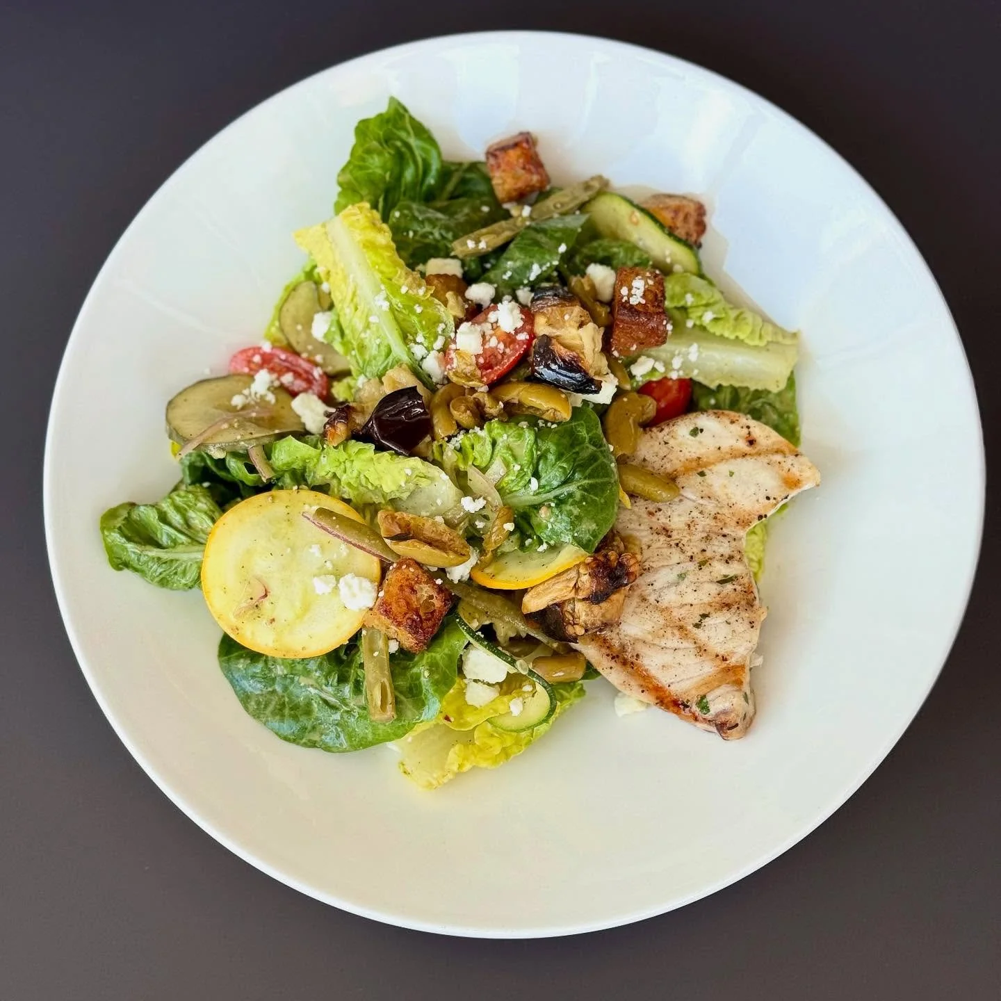 Grilled Swordfish and Baby Gem Lettuce Salad &bull; charred eggplant, fresh and pickled summer vegetables, roasted picholine olives, focaccia croutons, feta cheese, 1900 greek dressing 

📸 @branpanobread