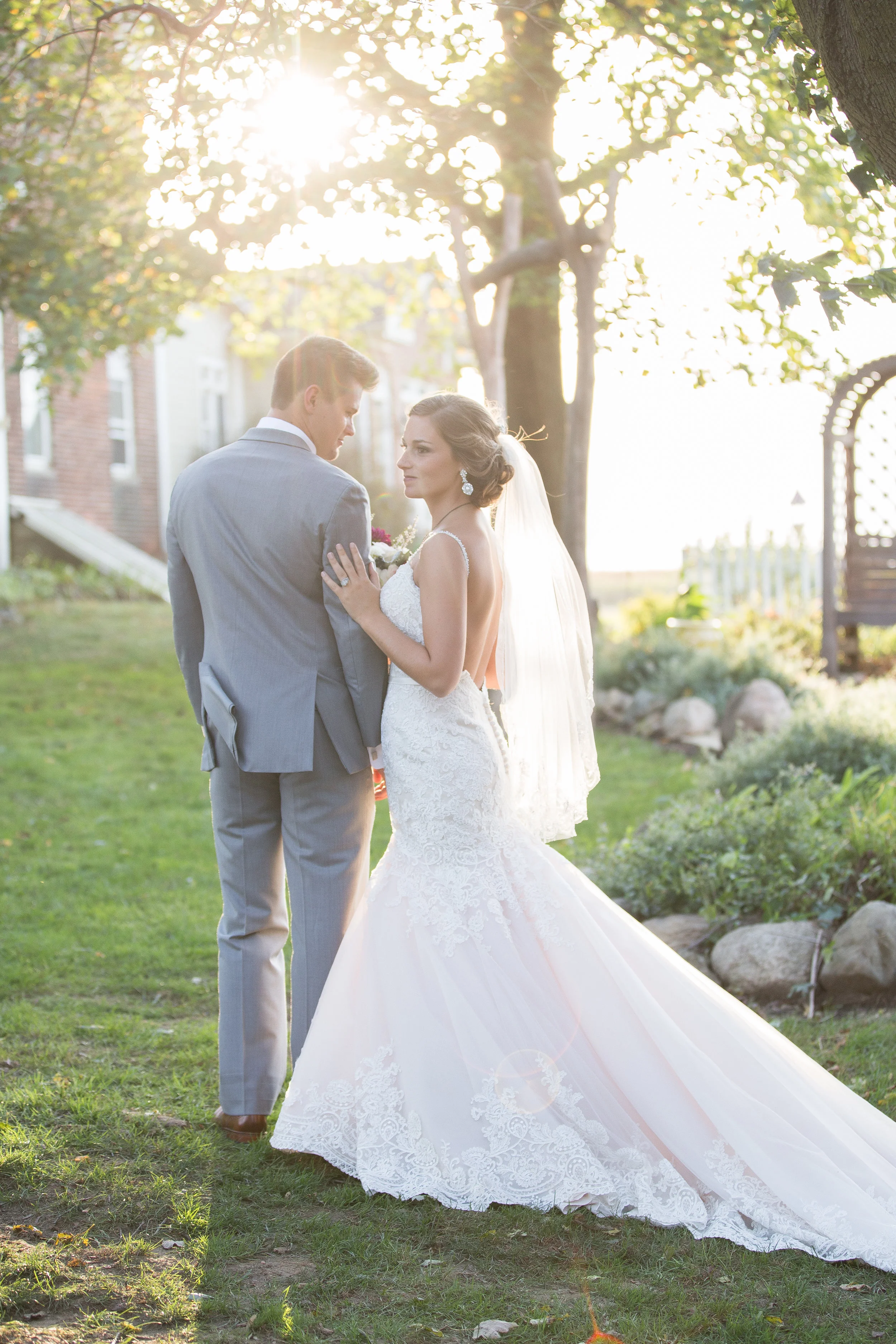 Portrait of bride and groom with sunlight beaming on them