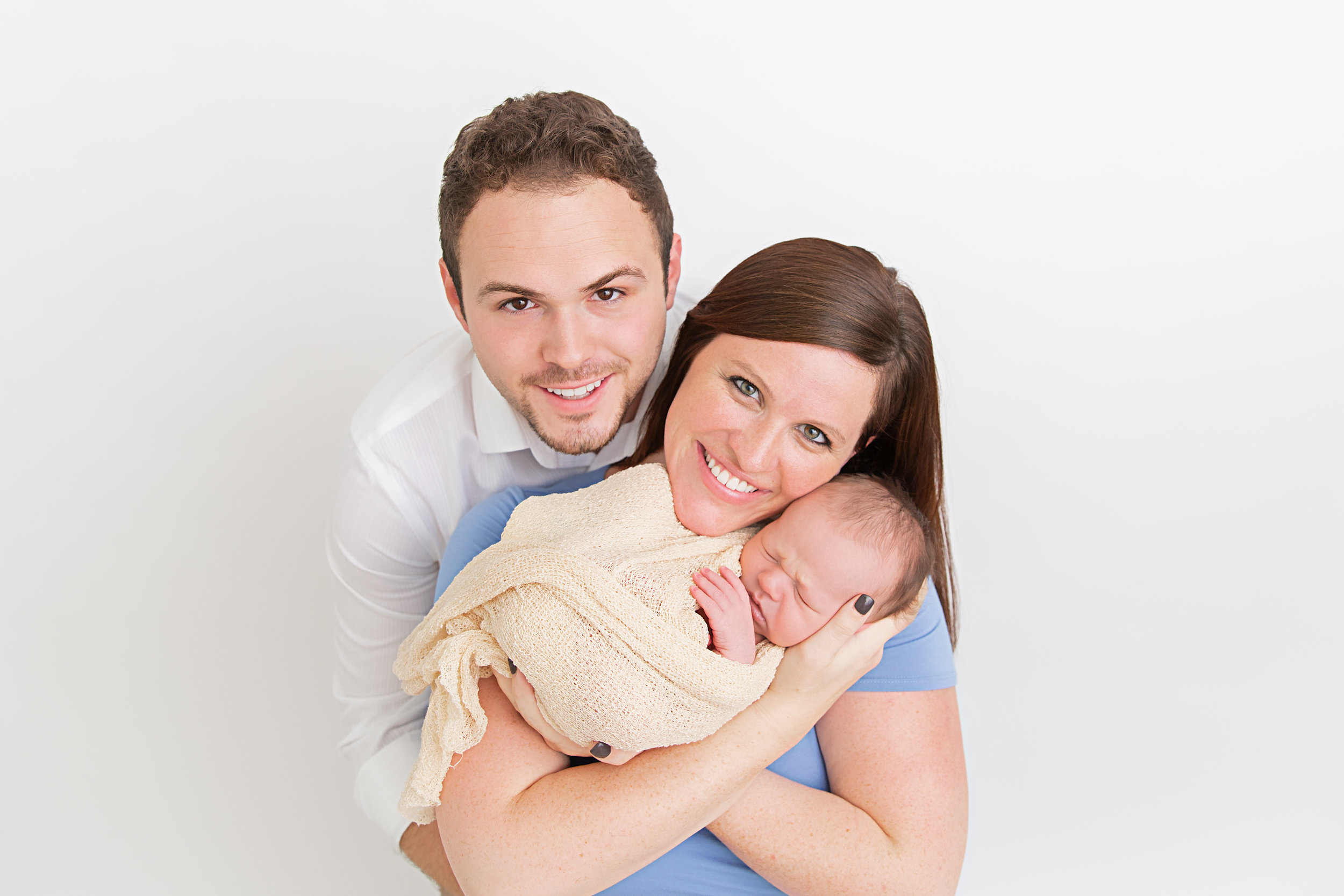 new parents and sleeping newborn baby boy