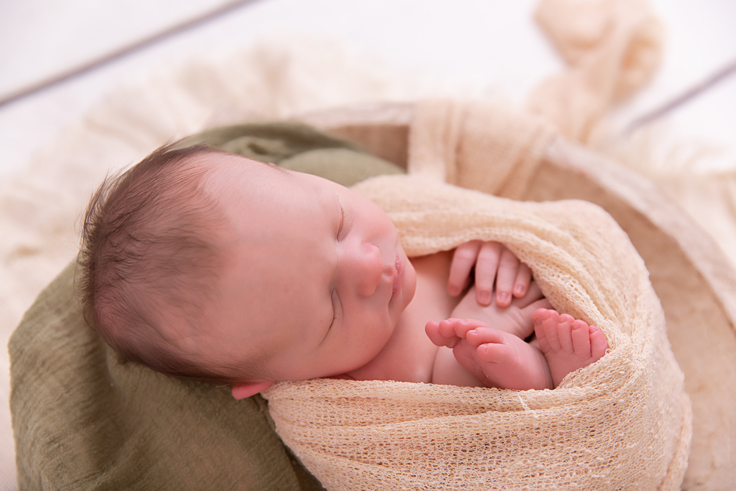 newborn baby boy in prop pose