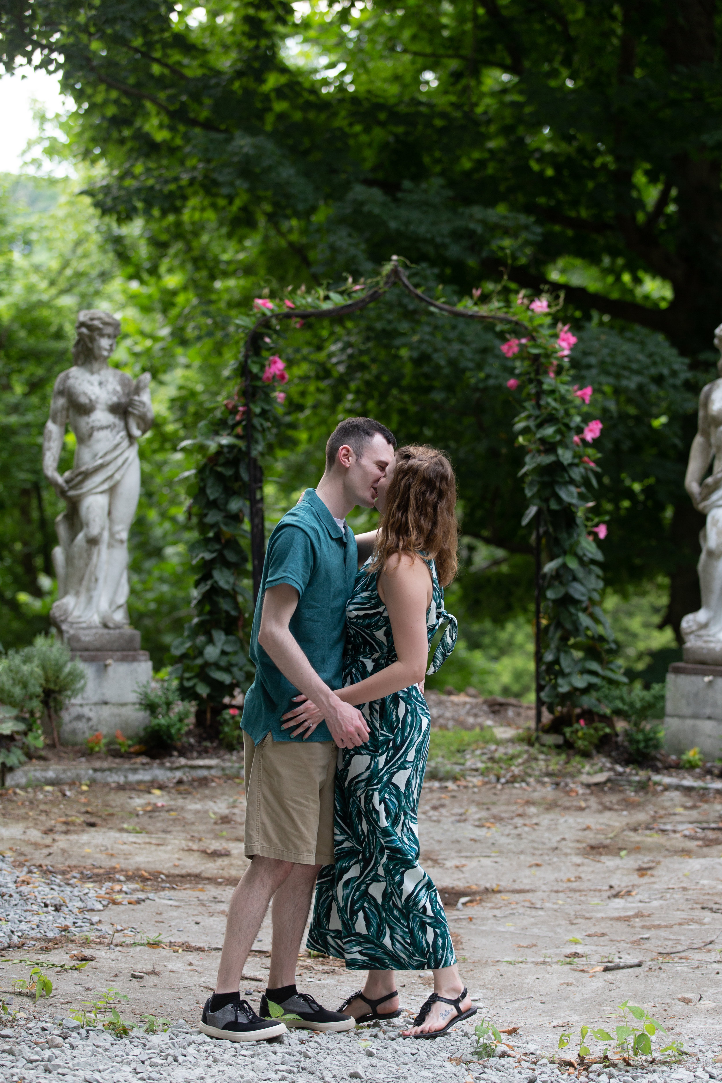 engaged couple kissing on outdoor lane